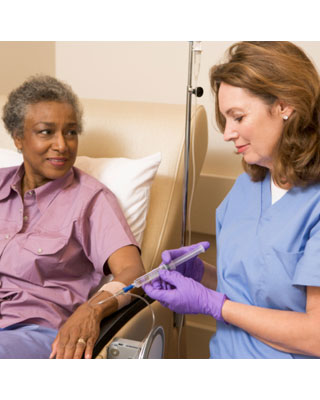 Woman receiving chemo from a healthcare provider