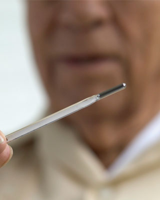 Man holding a thermometer