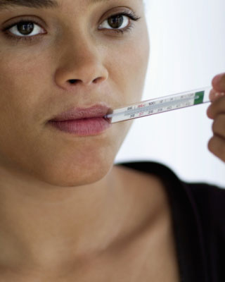 Woman taking her temperature