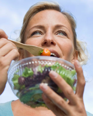 Lady eating a pre-washed salad